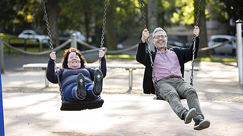 Man and woman on swings